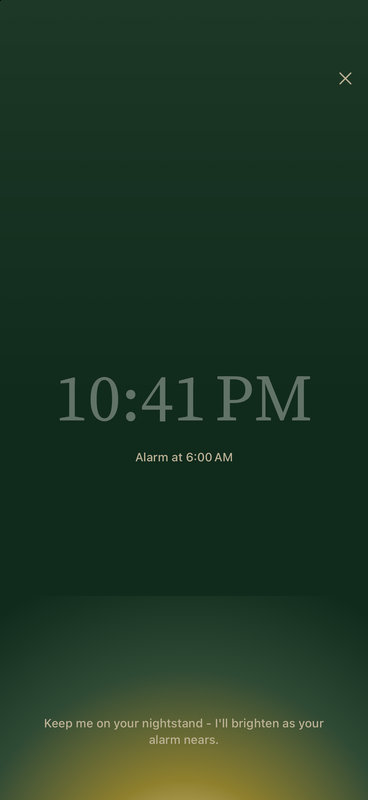 Bedside mode: a dimmed clock with the next alarm at 6:00 AM